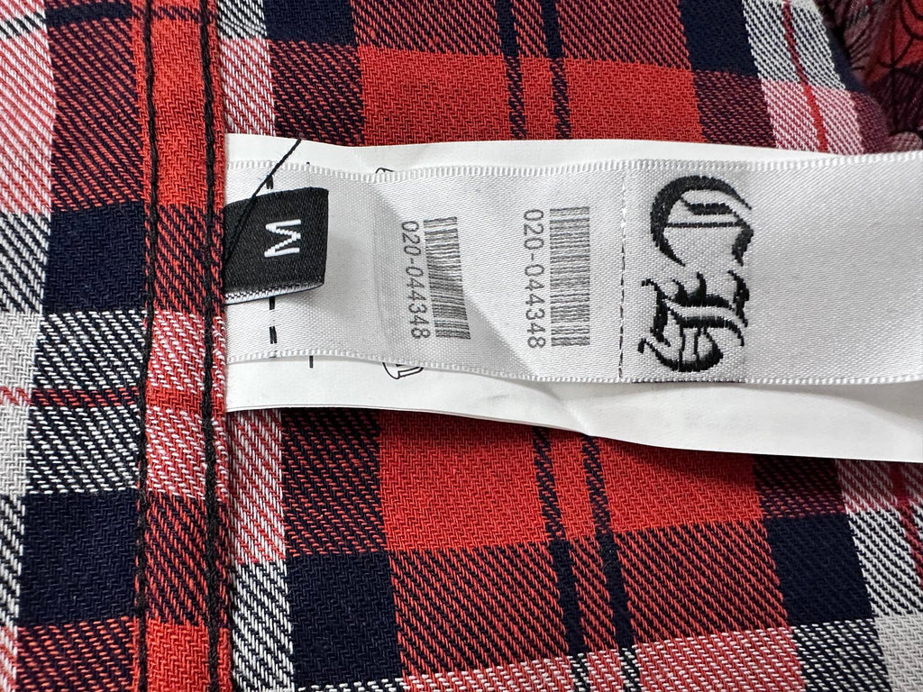 Plaid shirt care label with size tag and washing symbols