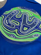 Blue varsity jacket back patch close-up with neon maze swirl graphic