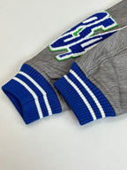 Louis Vuitton long-sleeve top, grey knit with blue striped cuffs and green-blue embroidery