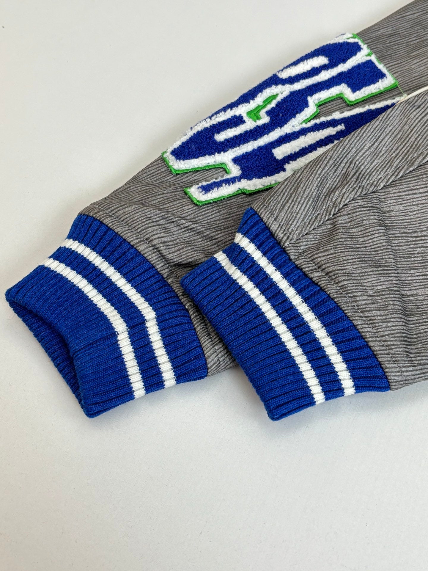 Louis Vuitton long-sleeve top, grey knit with blue striped cuffs and green-blue embroidery