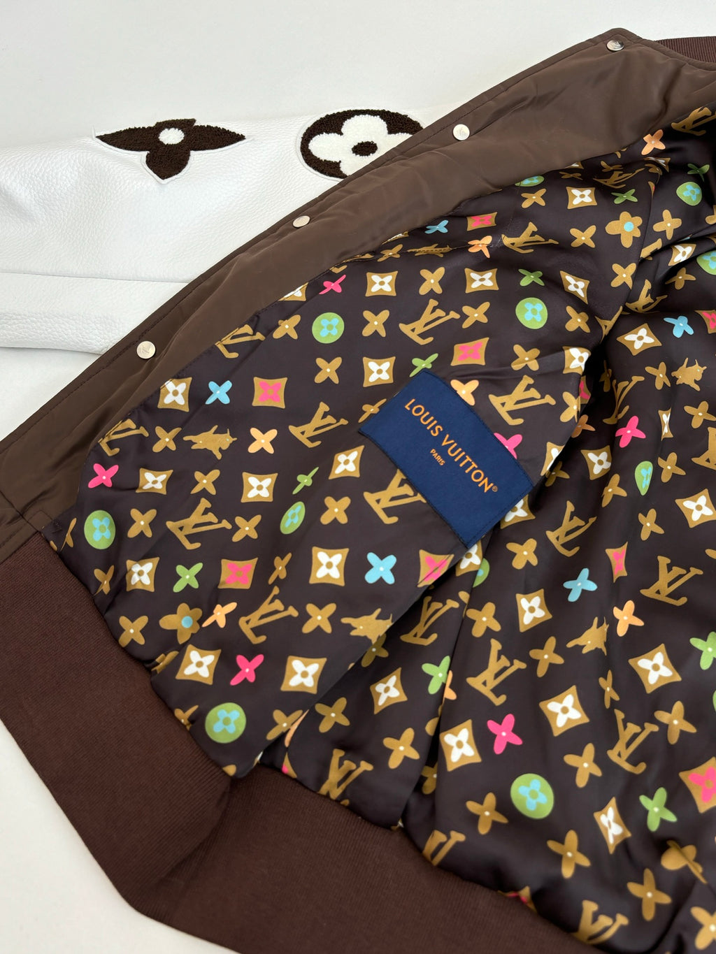 Louis Vuitton long jacket interior lining with multicolor monogram pattern and button placket