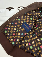 Louis Vuitton long jacket interior lining with multicolor monogram pattern and button placket