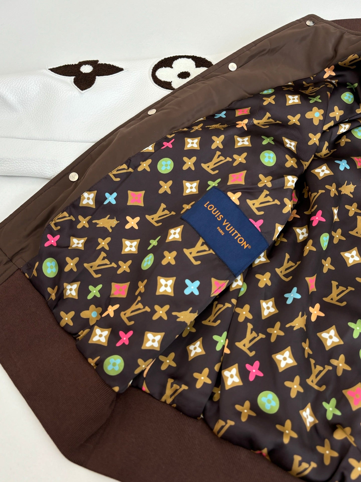 Louis Vuitton long jacket interior lining with multicolor monogram pattern and button placket
