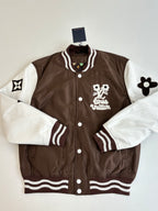 Louis Vuitton brown long jacket with white sleeves, striped cuffs, and front logo patch