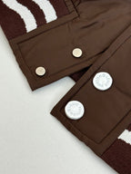Louis Vuitton long jacket close-up of brown button placket and striped ribbed trim