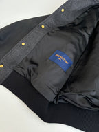 Gray varsity jacket interior lining with blue Louis Vuitton label and ribbed cuff