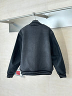 Dark gray varsity jacket back view with ribbed collar and black faux-leather sleeves