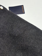 Dark gray textured wool varsity jacket fabric with embossed signature detail