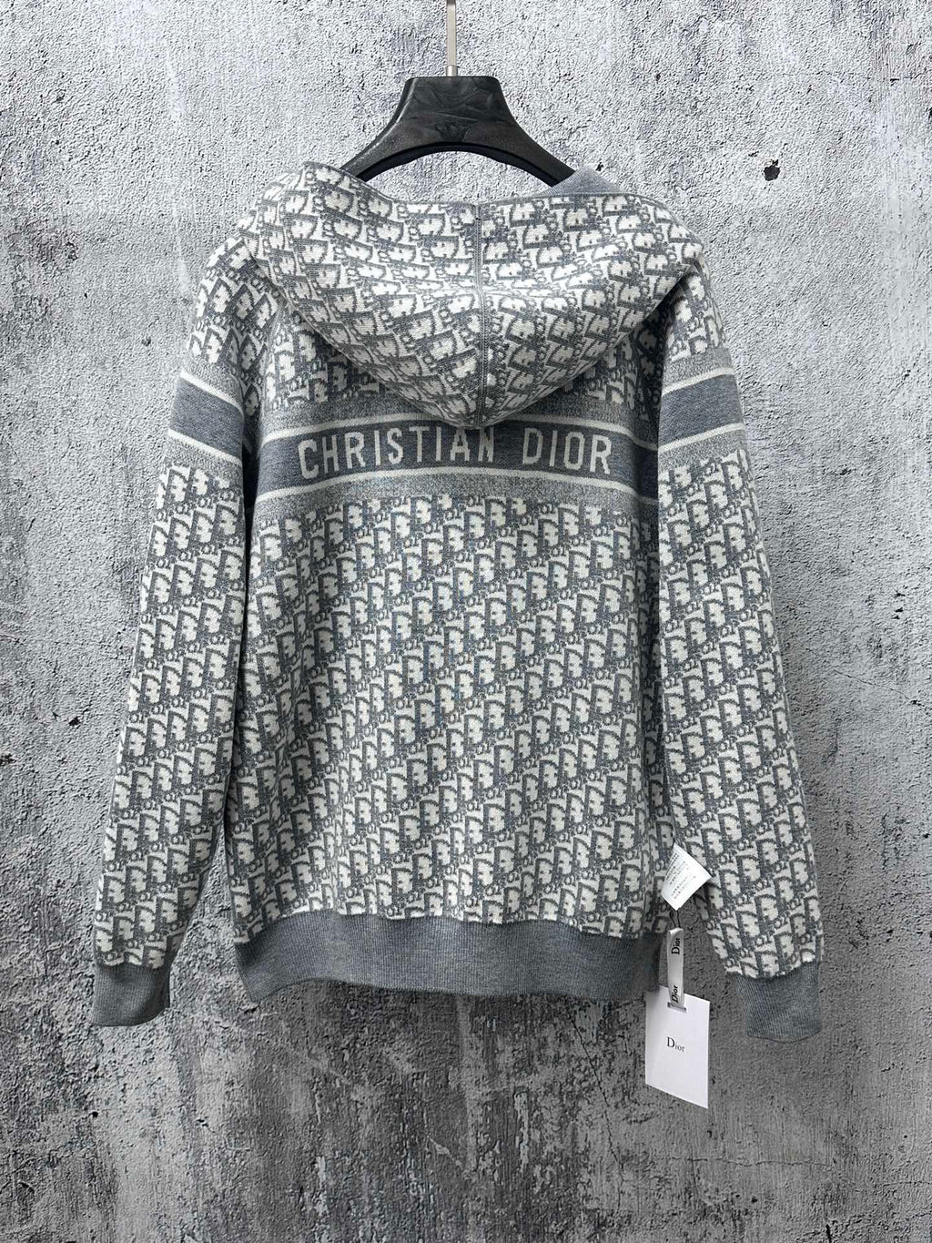 Gray zip-up hoodie with “Christian Dior” logo on patterned hood panel
