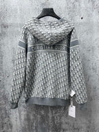 Gray zip-up hoodie with “Christian Dior” logo on patterned hood panel