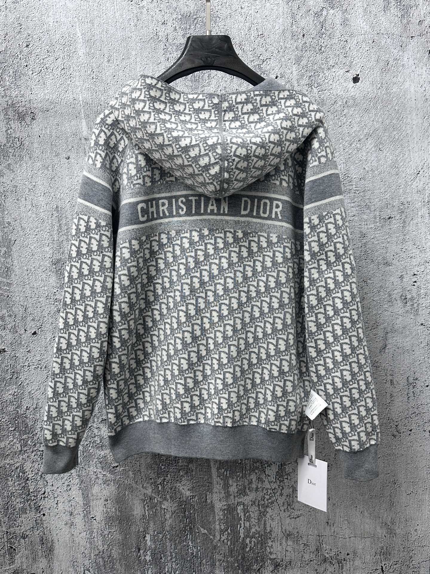 Gray zip-up hoodie with “Christian Dior” logo on patterned hood panel