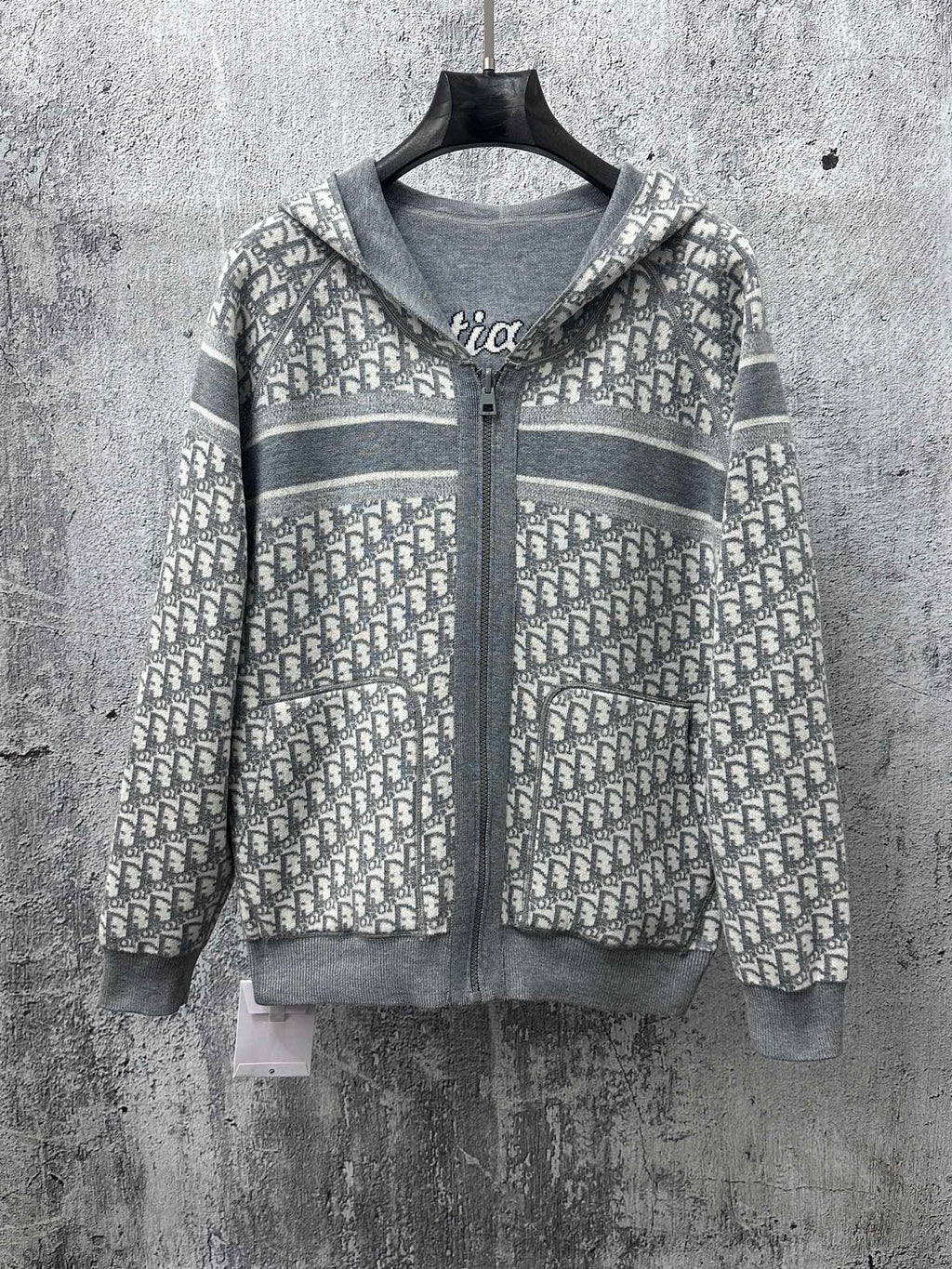 Gray zip-up hoodie with patterned hood and zip-front detail
