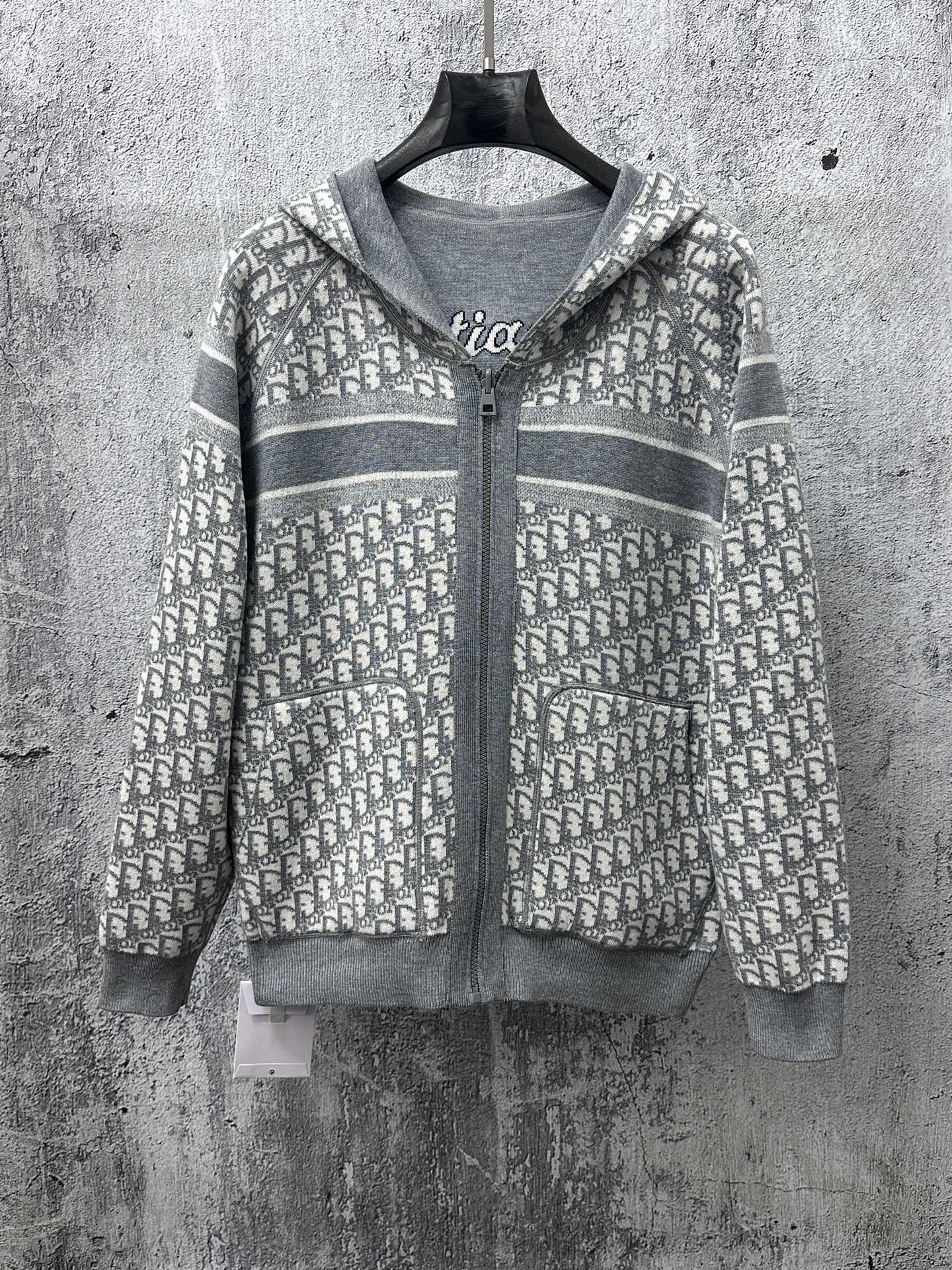 Gray zip-up hoodie with patterned hood and zip-front detail