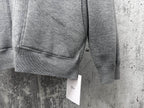 Gray zip-up hoodie close-up of ribbed hem and sleeve cuff