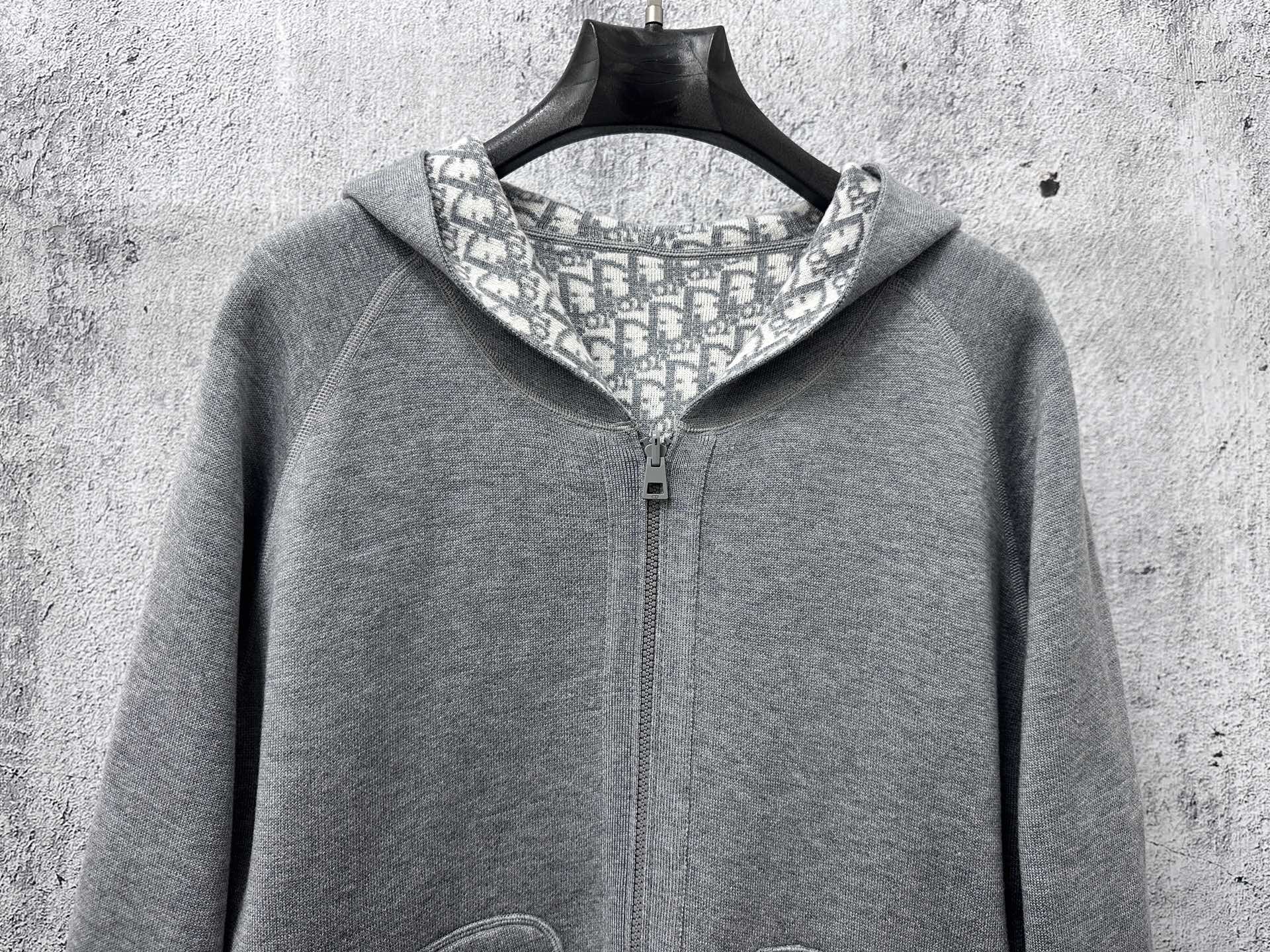 Gray zip-up hoodie with stand collar and front zipper closure