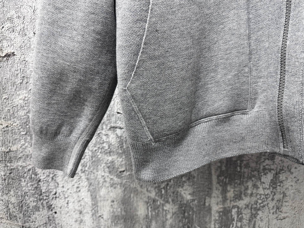 Gray hoodie close-up of zip-front and kangaroo pocket seam