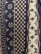 Front fabric close-up with monogram, checker, and star patterns beside button placket