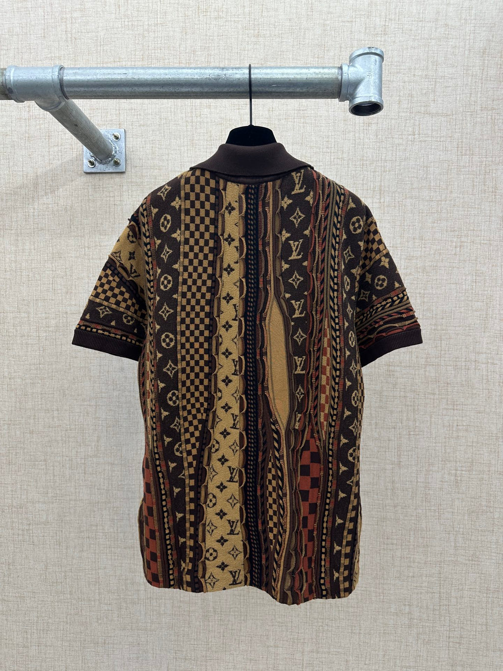 Back view of short-sleeve button-up shirt with monogram pattern and dark collar