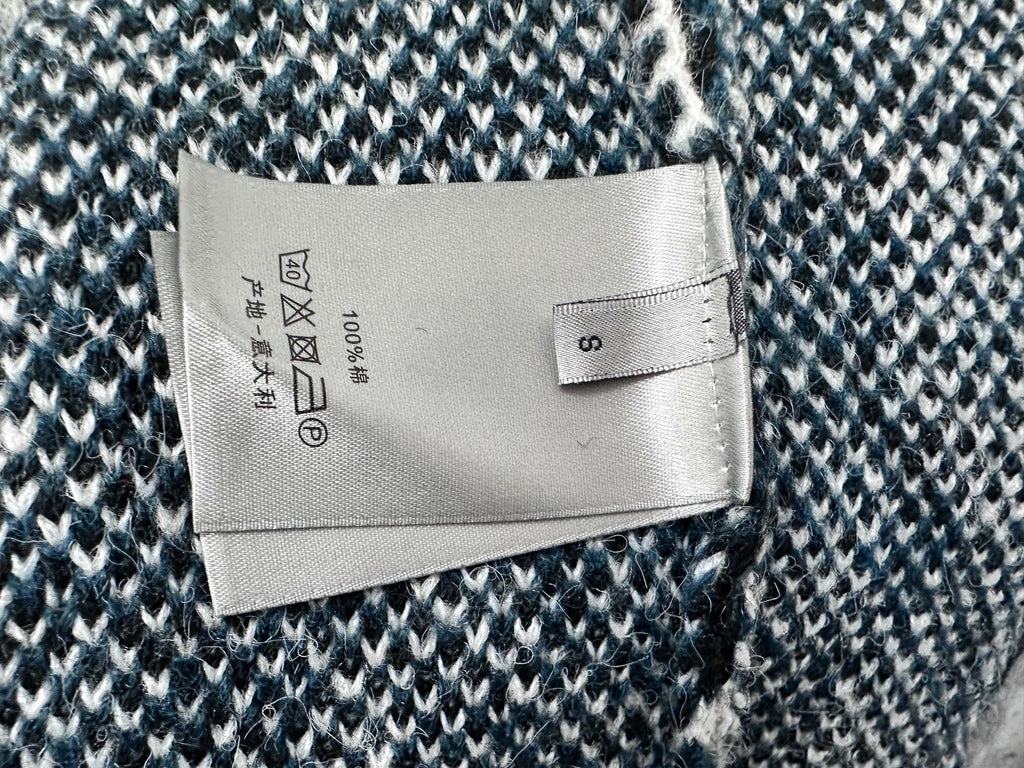 Dior long sweater care label on blue and white patterned fabric