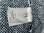 Dior long sweater care label on blue and white patterned fabric