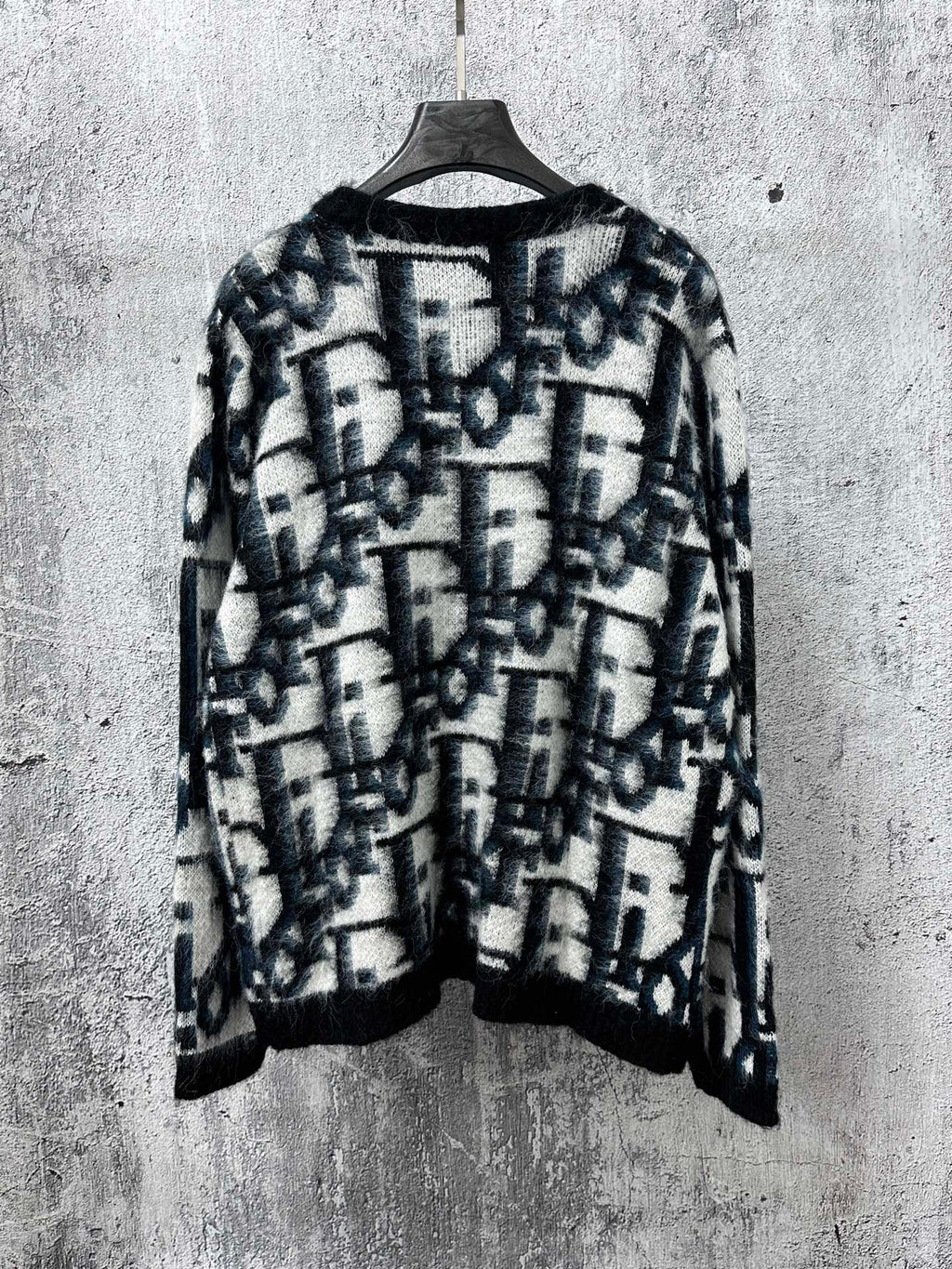 Dior long button-front sweater back view, blue and white abstract pattern on dark base
