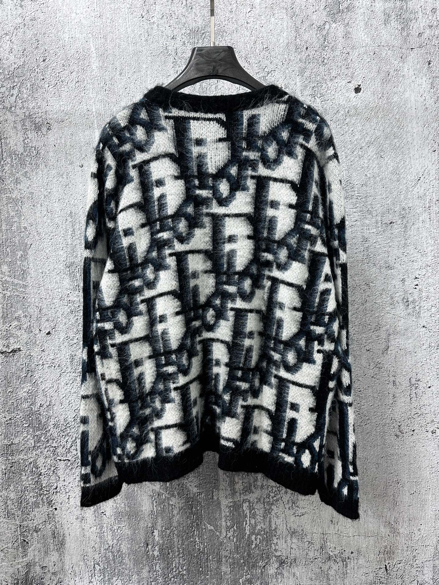 Dior long button-front sweater back view, blue and white abstract pattern on dark base