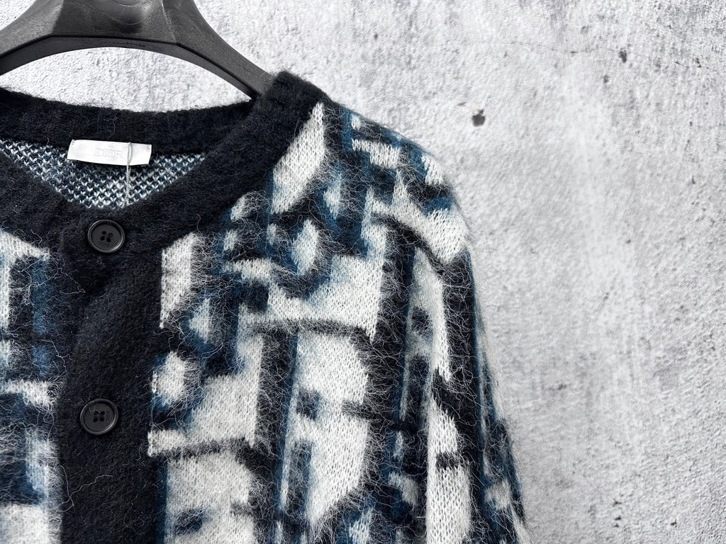 Dior long sweater neckline close-up with black button placket and blue abstract knit
