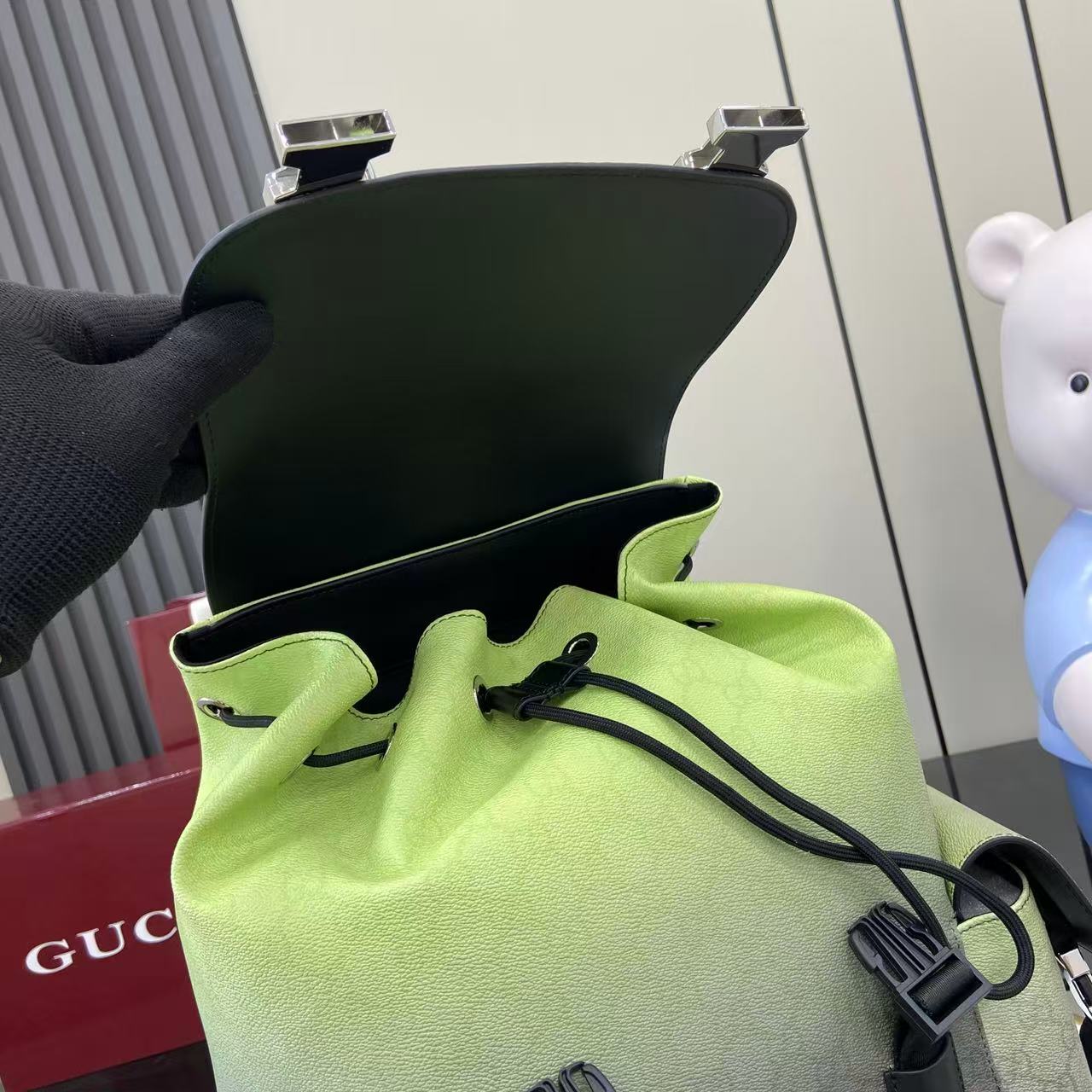 Gucci backpack interior opening with lime lining and drawstring cord at top