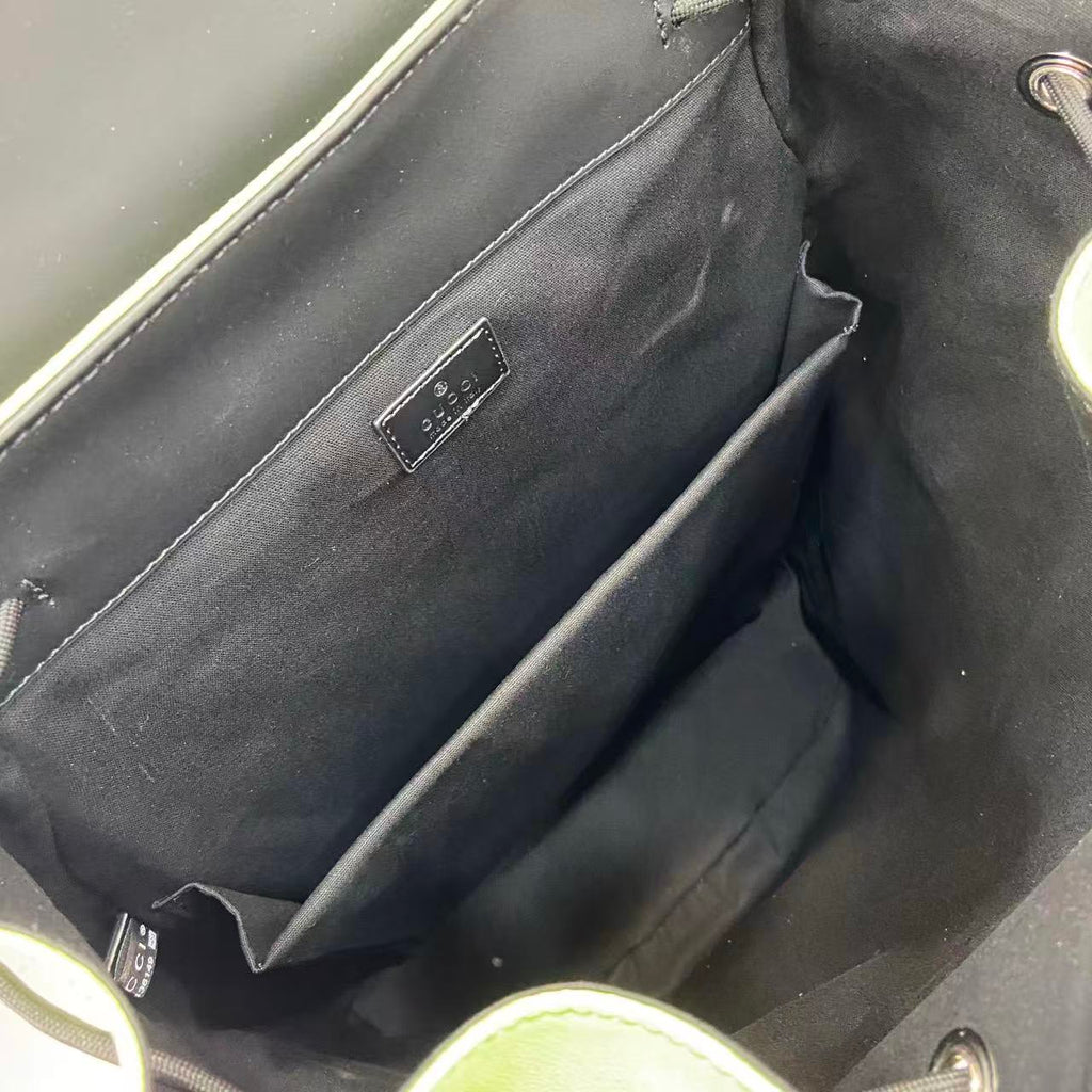 Gucci bag interior with dark lining and small rectangular logo label