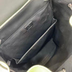 Gucci bag interior with dark lining and small rectangular logo label