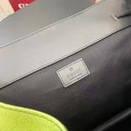 Gucci bag logo patch on dark fabric near a light trim seam