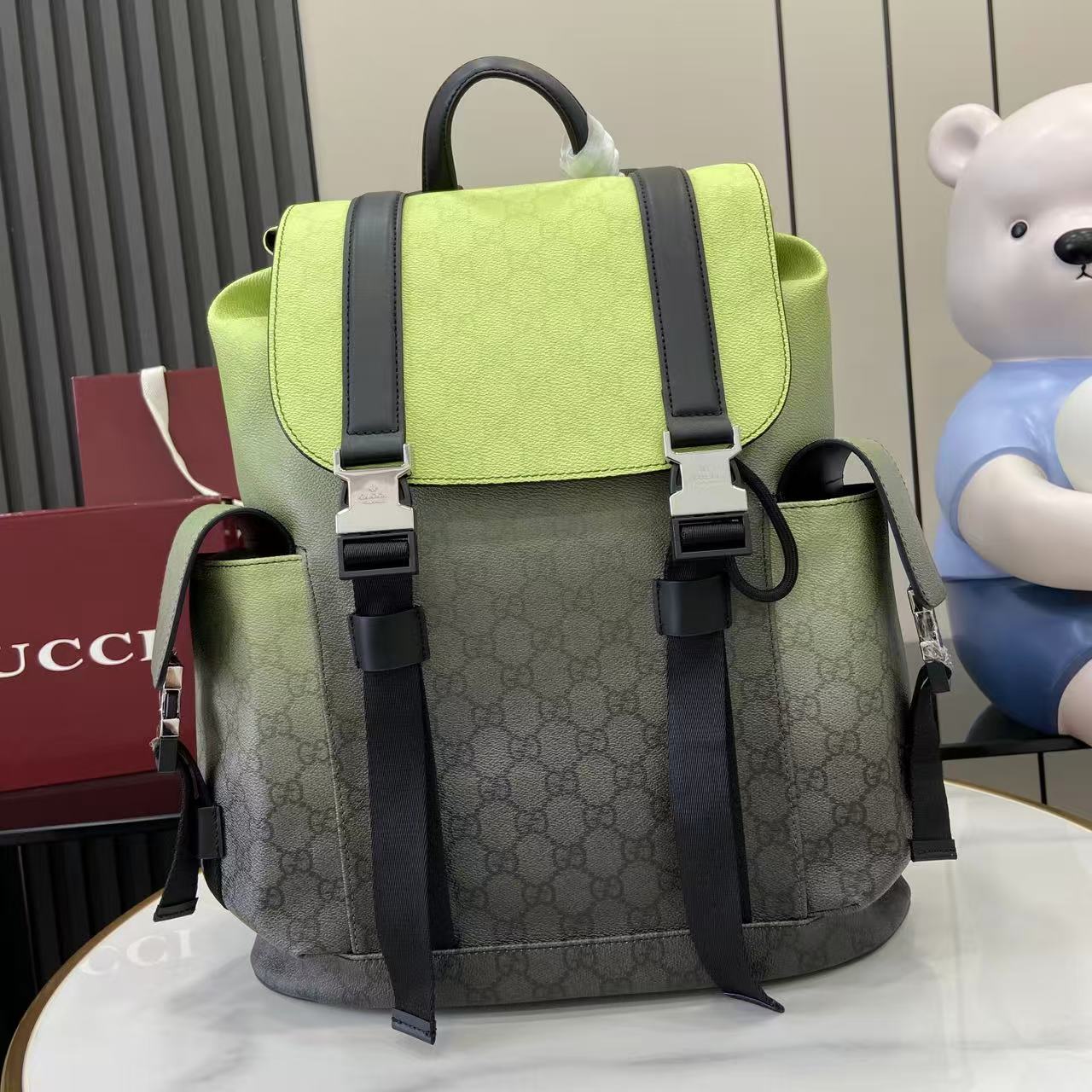 Gucci backpack with lime green flap, dark trim, and adjustable shoulder straps