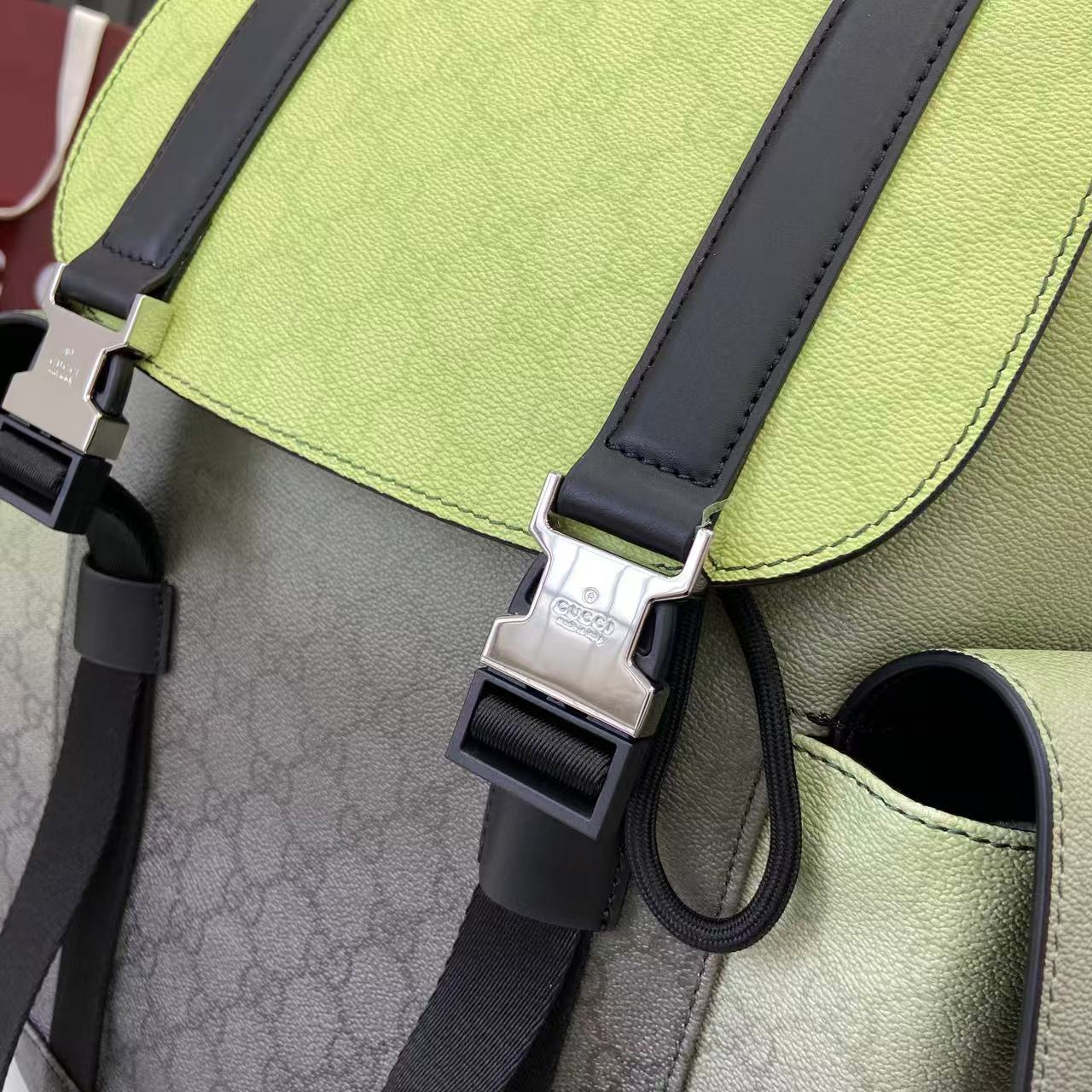 Gucci backpack close-up of lime green leather flap, dark straps, and metal buckle