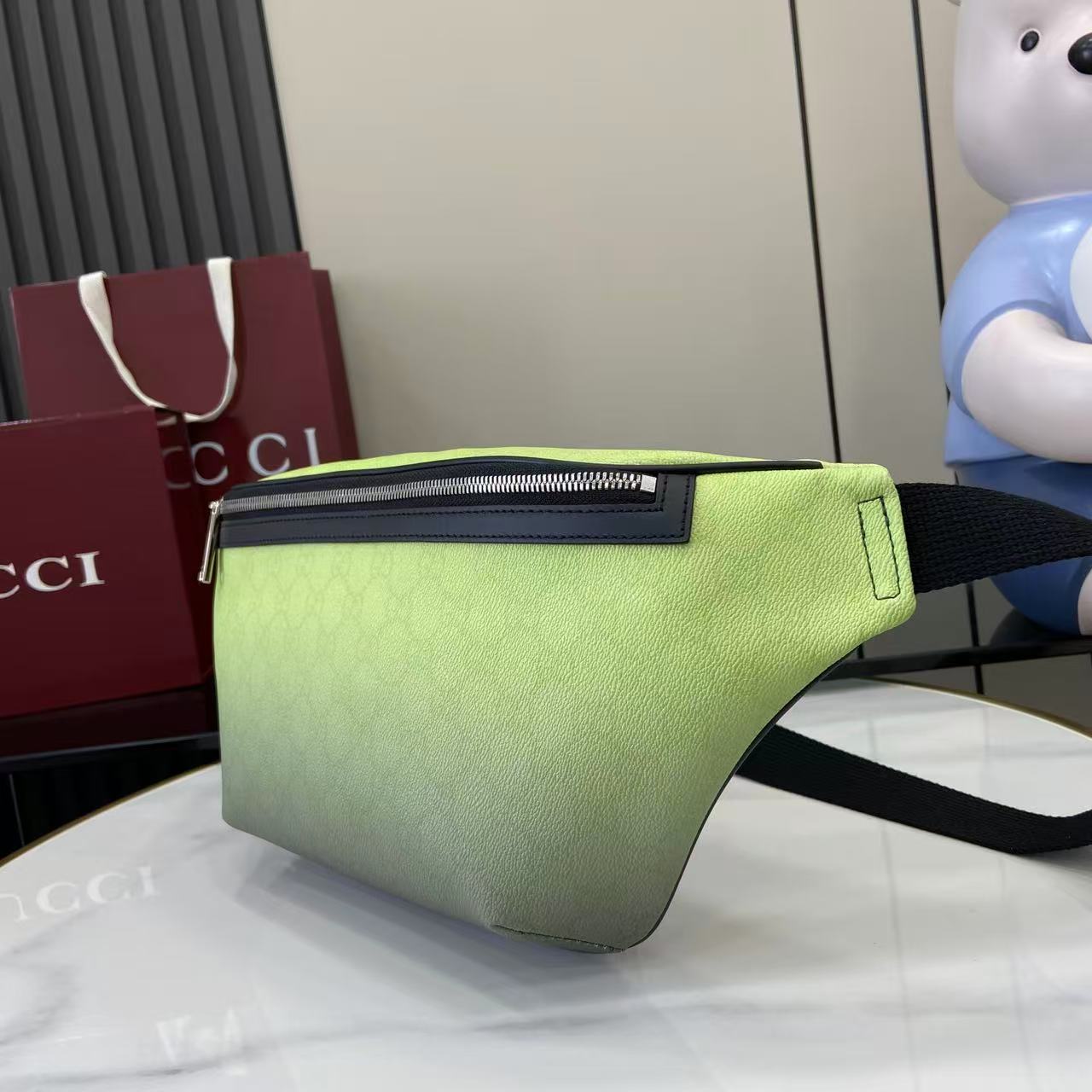Gucci lime green belt bag with black logo plaque on front zip pocket