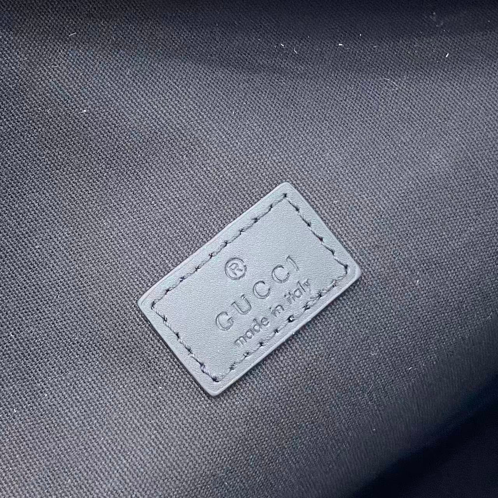 Gucci logo label on dark fabric with 'made in' text