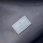 Gucci logo label on dark fabric with 'made in' text
