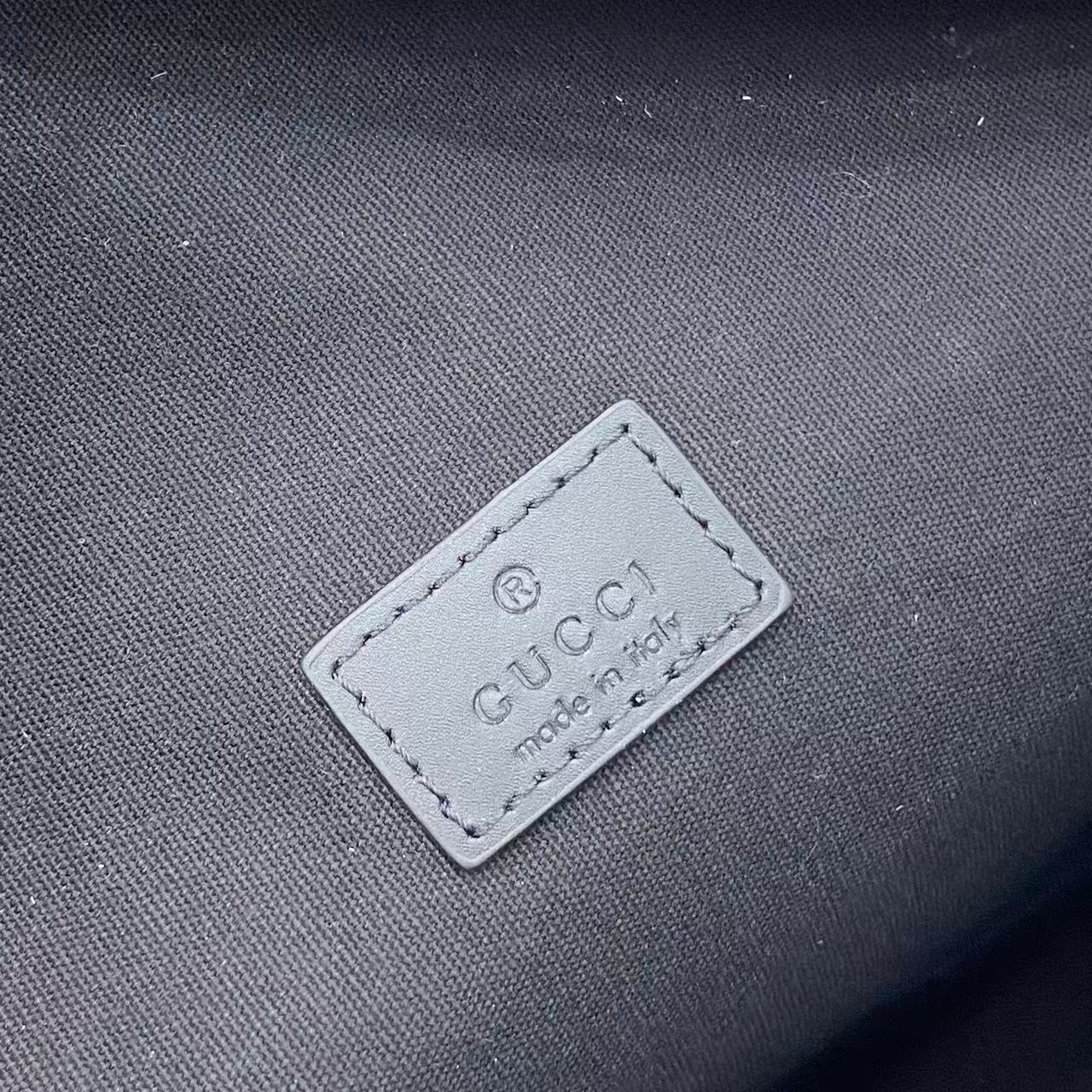 Gucci logo label on dark fabric with 'made in' text