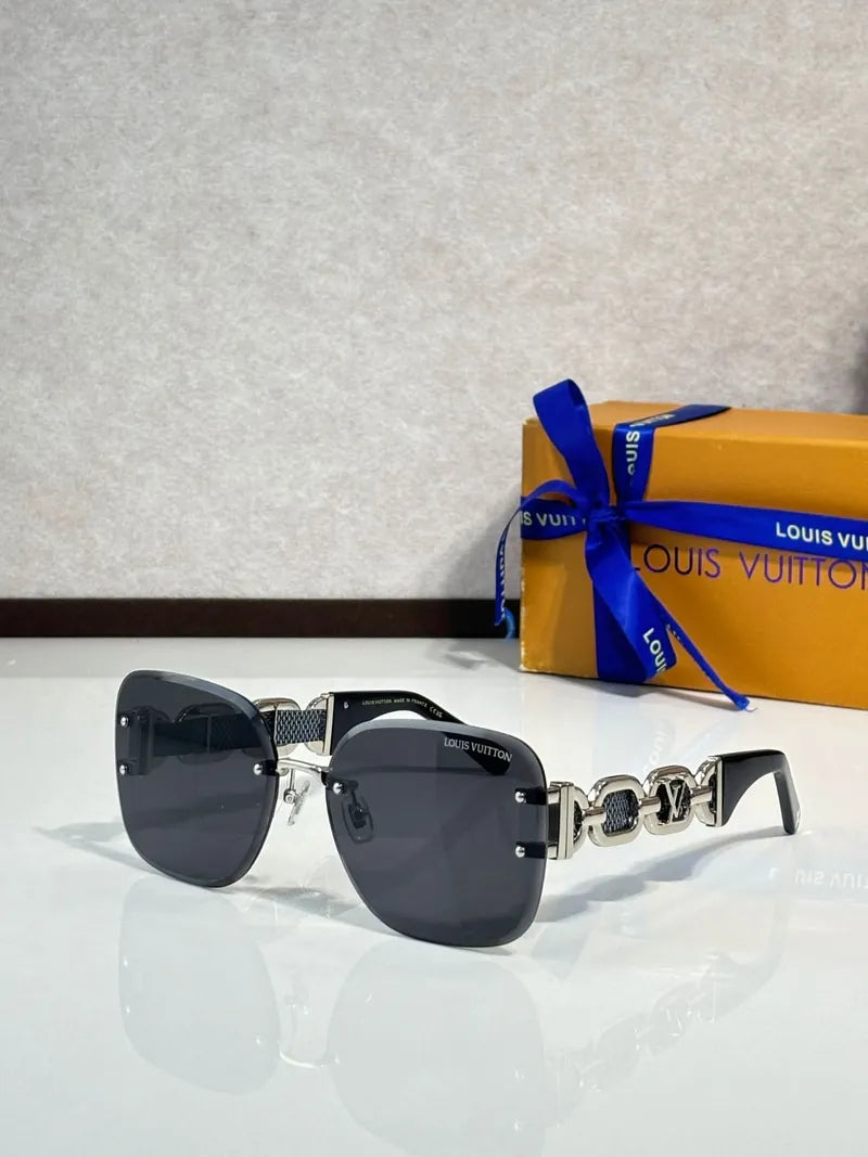 Oversized square sunglasses with dark lenses, black frames, and gold link temple detail