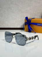 Louis Vuitton sunglasses, light blue lenses, light gray frame, gold logo temple detail