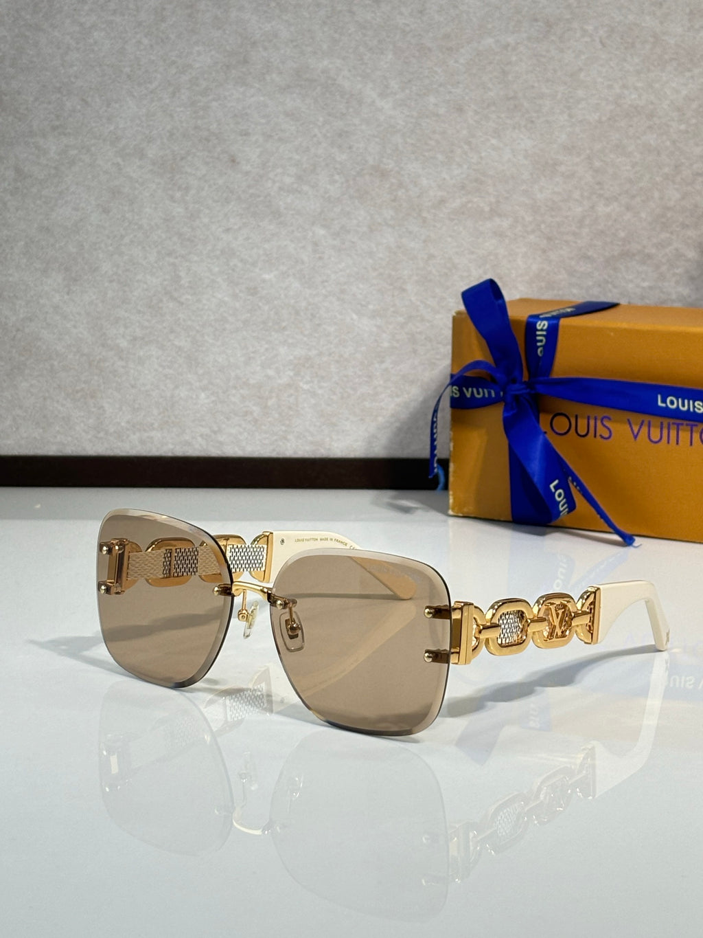 Louis Vuitton sunglasses, tan lenses, light gold frame, gold logo temple detail