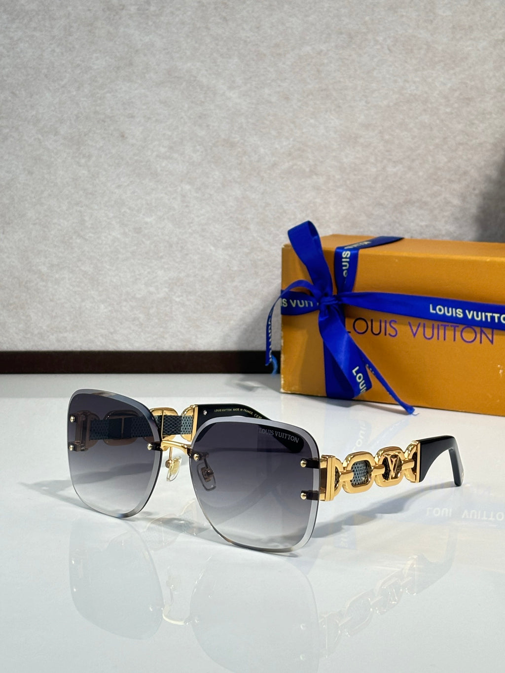 Louis Vuitton sunglasses, dark lenses, black frame, gold logo temple detail