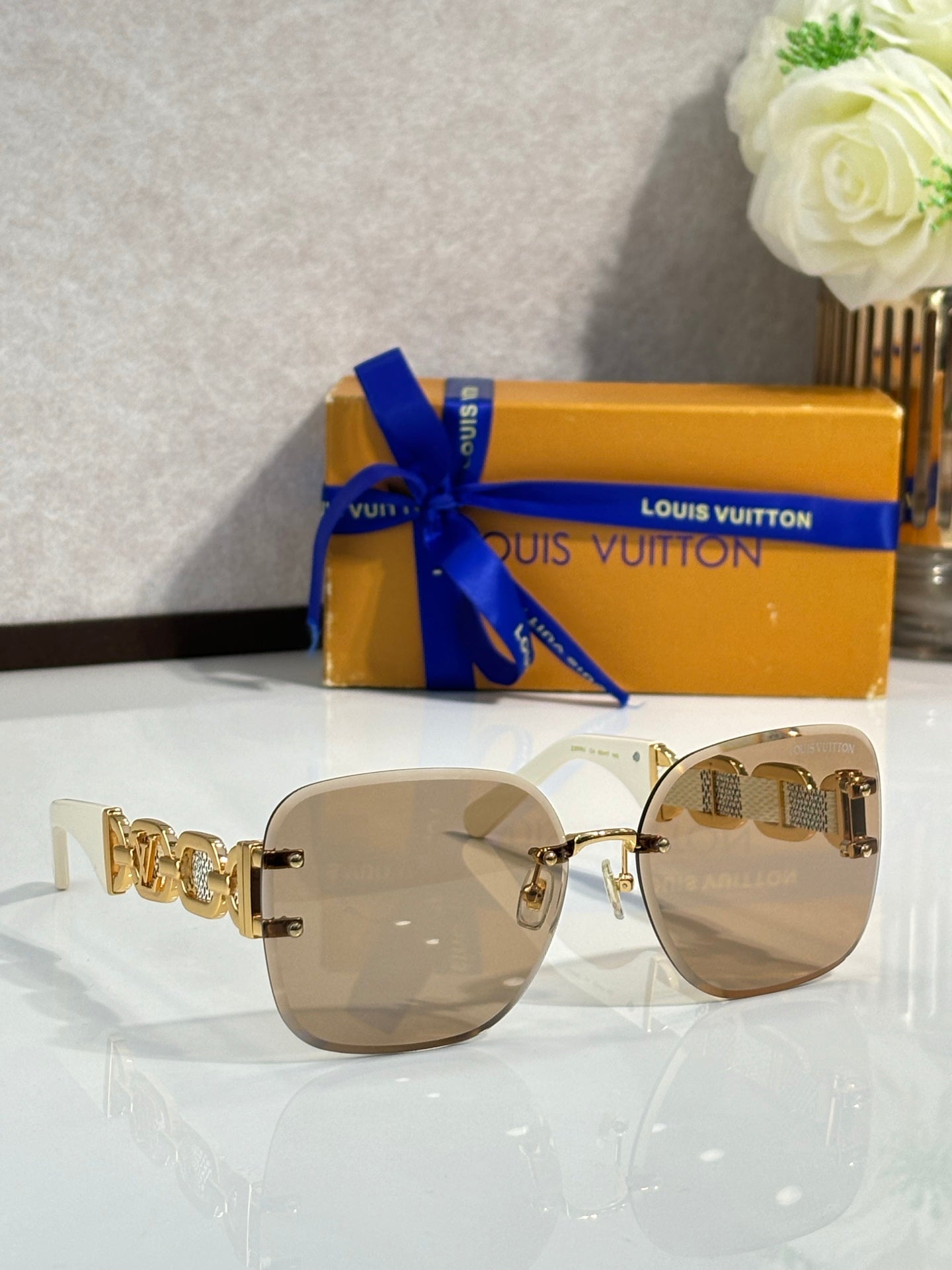Louis Vuitton sunglasses, rose-tinted lenses, gold frame, gold logo temple detail