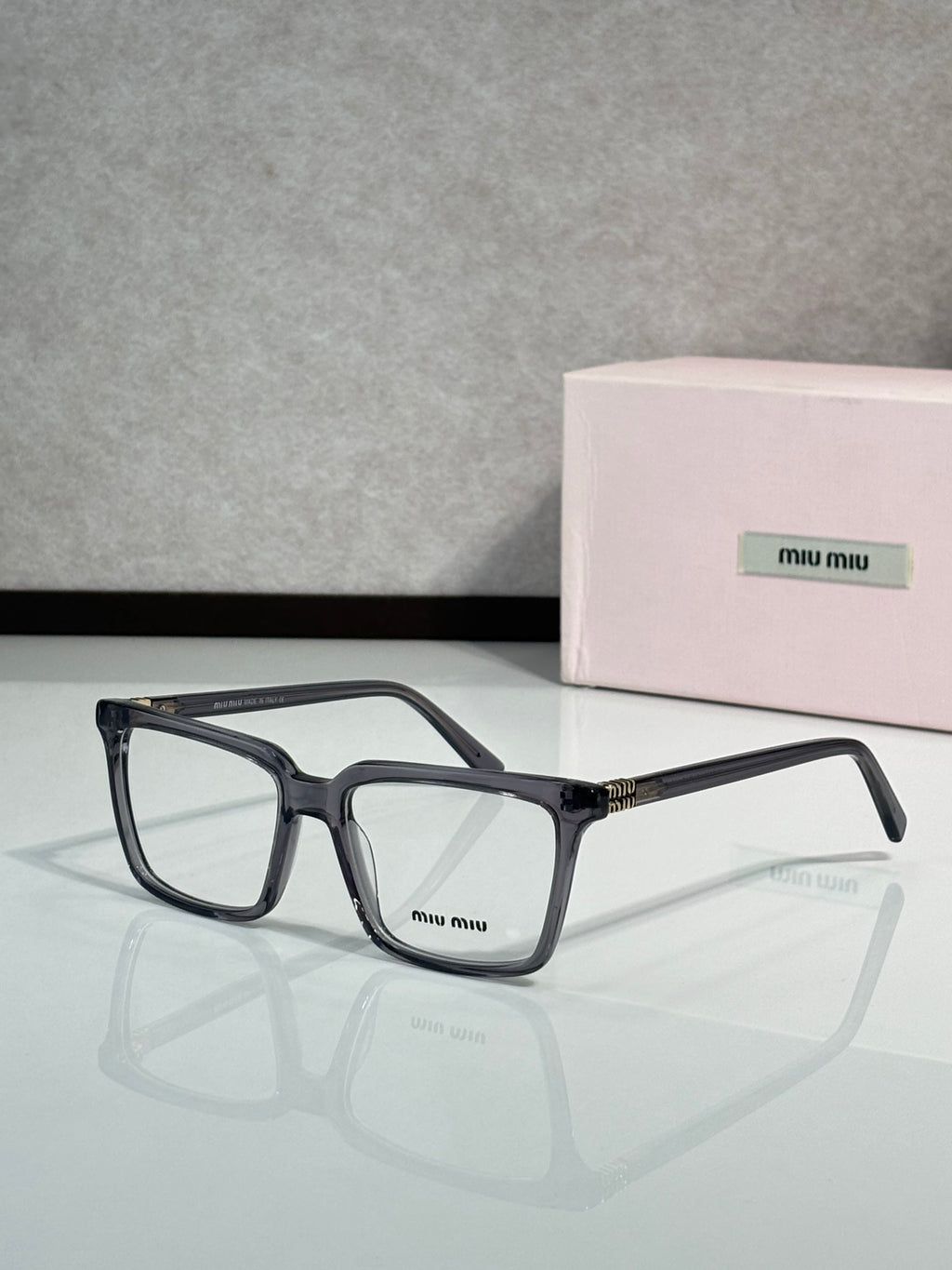 Black rectangular eyeglasses with Miu Miu logo on the front