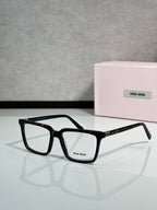 Black rectangular eyeglasses with Miu Miu logo and gold hinge detail