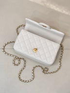 Chanel quilted mini flap bag with top handle, white interior lining and gold detail
