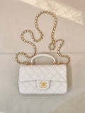 Chanel quilted mini flap bag in white with gold chain strap and CC turn-lock