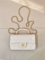 Chanel quilted mini flap bag in white with gold chain strap and CC turn-lock