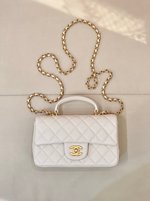 Chanel quilted mini flap bag in white with gold chain strap and CC turn-lock