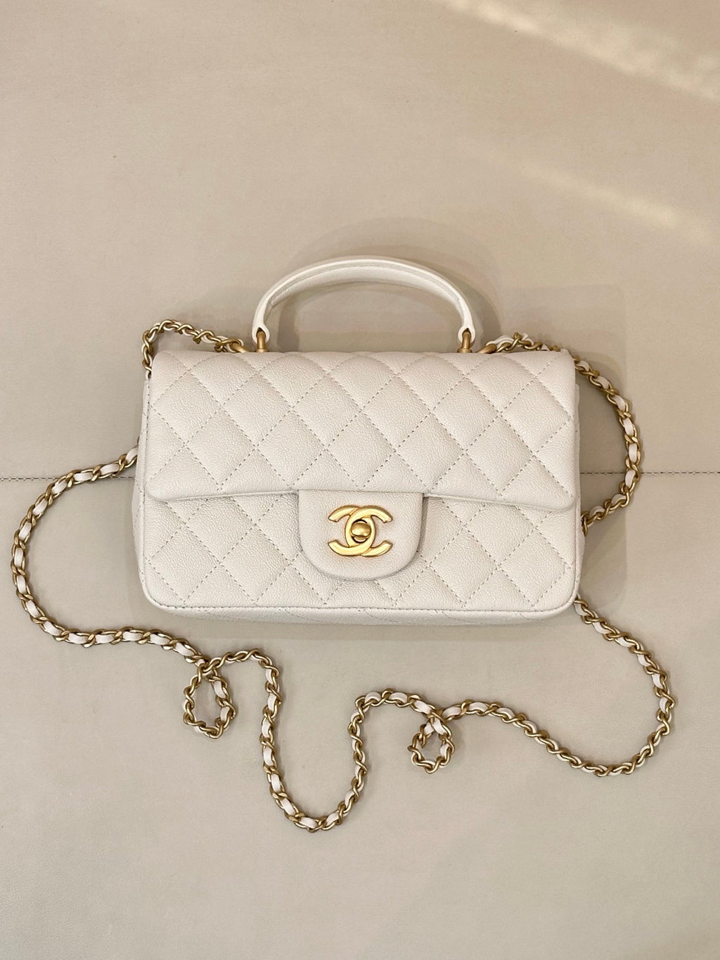 Chanel quilted mini flap bag, white with gold chain strap and front CC emblem