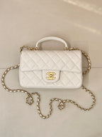 Chanel quilted mini flap bag, white with gold chain strap and front CC emblem